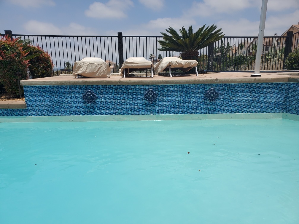 San Diego Pool Tile Cleaning removing mineral deposits from pool tile in San Diego, California