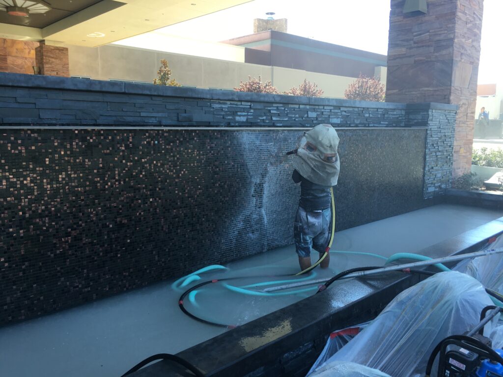 san diego pool tile cleaning worker doing media blasting